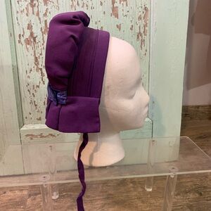 Purple bonnet with blue ribbon detail